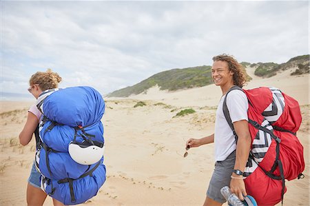 parachute, beach - Portrait happy male paraglider with parachute backpack on beach Stock Photo - Premium Royalty-Free, Code: 6113-09168485