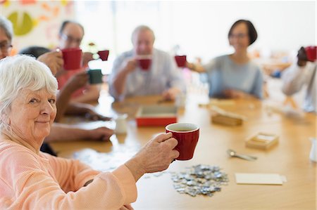 simsearch:6113-09131534,k - Portrait happy senior woman enjoying afternoon tea with friends in community center Stock Photo - Premium Royalty-Free, Code: 6113-09168402