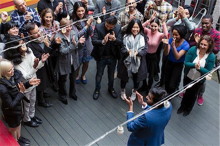 simsearch:6113-07730693,k - Business people clapping for businessman, celebrating on patio Stock Photo - Premium Royalty-Free, Code: 6113-09168574