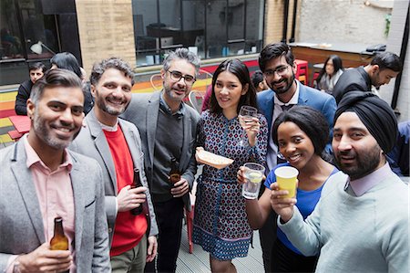 Portrait smiling friends drinking at party on patio Stock Photo - Premium Royalty-Free, Code: 6113-09168598