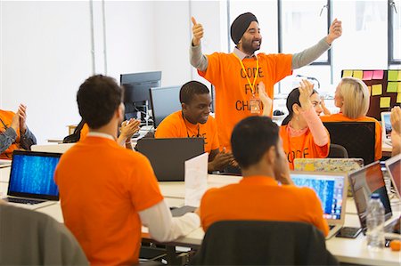 Hackers cheering, coding for charity at hackathon Foto de stock - Sin royalties Premium, Código: 6113-09168683