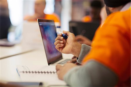 Hacker at laptop coding for charity at hackathon Stock Photo - Premium Royalty-Free, Code: 6113-09168691