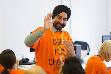 simsearch:6113-09168615,k - Happy hackers high-fiving, coding for charity at hackathon Stock Photo - Premium Royalty-Free, Code: 6113-09168694