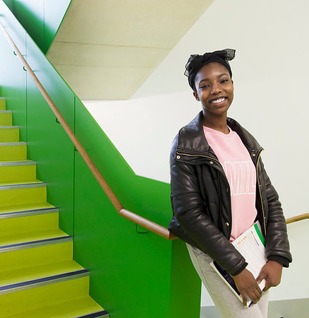 Portrait smiling, confident high school girl in stairway Stock Photo - Premium Royalty-Free, Code: 6113-09178544