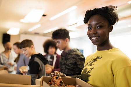 simsearch:400-04635813,k - Portrait smiling teenage girl enjoying pizza with friends in community center Stock Photo - Premium Royalty-Free, Code: 6113-09178559