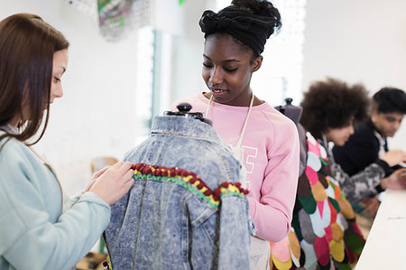 Teenage girls designing denim jacket in fashion design class Stock Photo - Premium Royalty-Free, Code: 6113-09178575