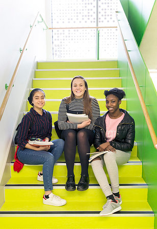 simsearch:6113-09178571,k - Portrait smiling, confident high school girls sitting on stairs Photographie de stock - Premium Libres de Droits, Code: 6113-09178576