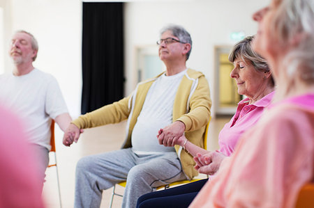 peace of mind and seniors - Serene active seniors holding hands, meditating Stock Photo - Premium Royalty-Free, Code: 6113-09178653