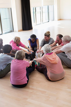 senior community living centers - Active seniors stretching legs in circle Stock Photo - Premium Royalty-Free, Code: 6113-09178662