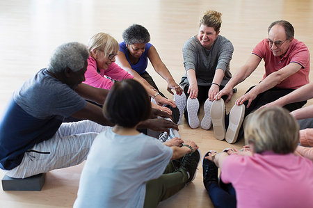 southeast - Smiling active seniors stretching legs in circle Stock Photo - Premium Royalty-Free, Code: 6113-09178630