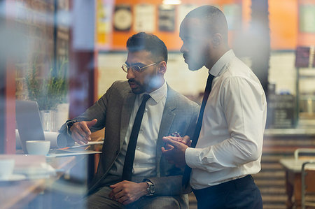 see city - Businessmen working at laptop in cafe Stock Photo - Premium Royalty-Free, Code: 6113-09178754