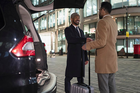 simsearch:400-04574012,k - Businessmen with suitcase handshaking at back of car on urban street at night Stock Photo - Premium Royalty-Free, Code: 6113-09178836