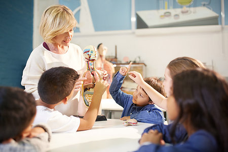 Teacher and curious students with anatomical model in science center Stock Photo - Premium Royalty-Free, Code: 6113-09178943