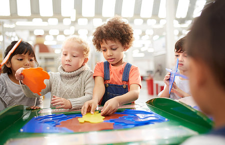 school boy standing and looking up - Kids playing at interactive exhibit in science center Stock Photo - Premium Royalty-Free, Code: 6113-09178945