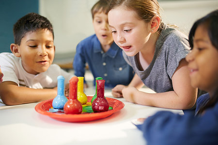 Curious kids watching multicolor foam in beakers Stock Photo - Premium Royalty-Free, Code: 6113-09178957