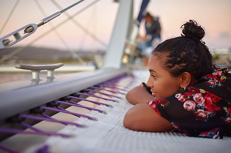 simsearch:6113-09179023,k - Serene young woman relaxing on catamaran Photographie de stock - Premium Libres de Droits, Code: 6113-09178982