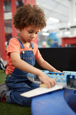 Curious girl playing in science center Stock Photo - Premium Royalty-Free, Code: 6113-09178920