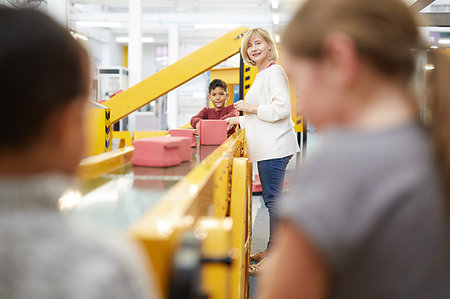 simsearch:649-09269303,k - Teacher and students playing at interactive construction exhibit in science center Stock Photo - Premium Royalty-Free, Code: 6113-09178924