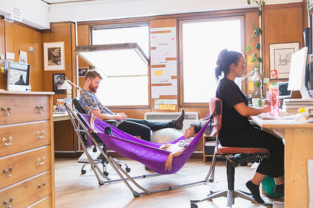 Creative designers relaxing in hammock in office Stock Photo - Premium Royalty-Free, Code: 6113-09179081