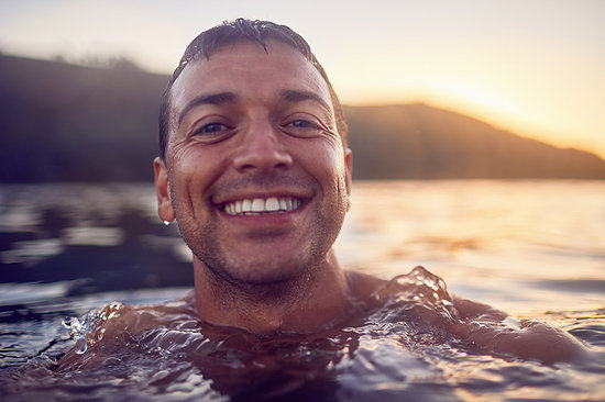 Close up portrait smiling, carefree man swimming in ocean Stock Photo - Premium Royalty-Free, Image code: 6113-09179005