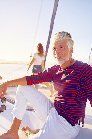 simsearch:6113-09179043,k - Portrait confident man relaxing on sunny boat Stock Photo - Premium Royalty-Free, Code: 6113-09179017