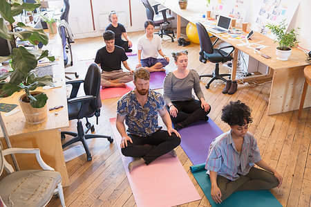 Serene creative business people meditating in office Stock Photo - Premium Royalty-Free, Code: 6113-09179198