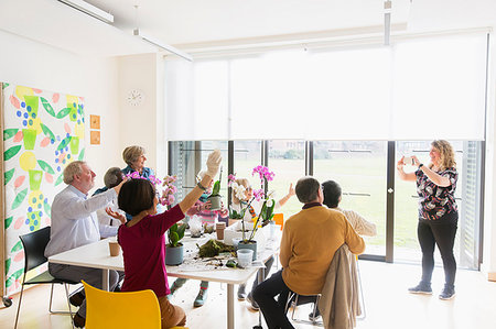 flower arrangement for women - Instructor photographing active seniors enjoying flower arranging class Stock Photo - Premium Royalty-Free, Code: 6113-09191856