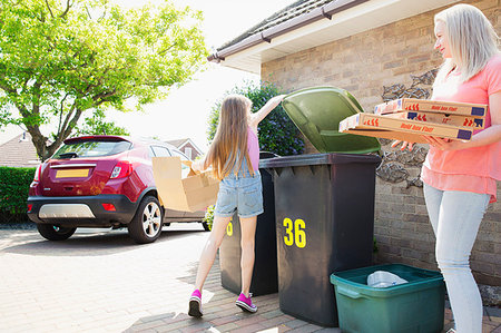 Mother and daughter recycling cardboard in driveway Stock Photo - Premium Royalty-Free, Code: 6113-09191964