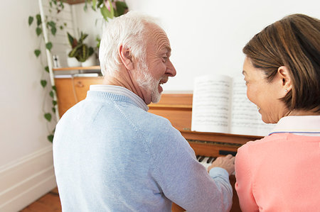 score - Active senior couple playing piano Stock Photo - Premium Royalty-Free, Code: 6113-09192020