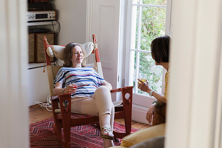 Senior women friends talking in living room Stock Photo - Premium Royalty-Free, Code: 6113-09192024