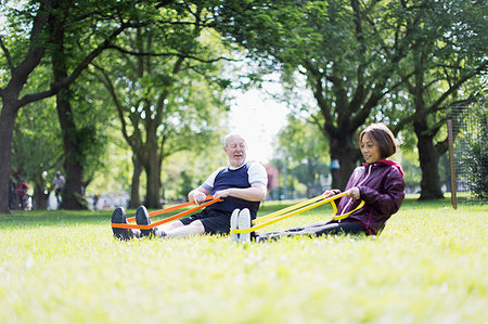 resistance band and men - Active senior couple exercising, using resistance bands in park Stock Photo - Premium Royalty-Free, Code: 6113-09199783