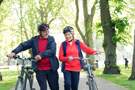 simsearch:649-06844544,k - Active senior couple walking bikes in park Stock Photo - Premium Royalty-Free, Code: 6113-09199818