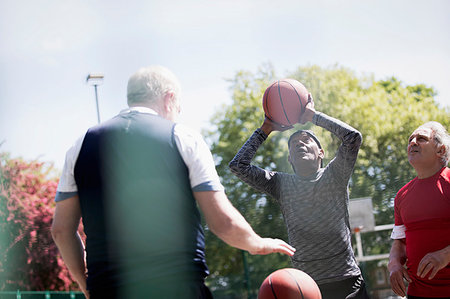 simsearch:6113-09131576,k - Active senior men playing basketball in sunny park Stock Photo - Premium Royalty-Free, Code: 6113-09199819