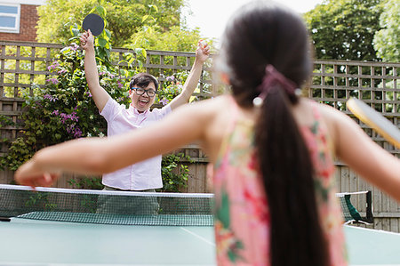 simsearch:6113-09131576,k - Exuberant father and daughter playing table tennis Stock Photo - Premium Royalty-Free, Code: 6113-09199953