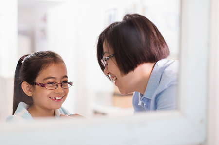 Reflection of mother and daughter in bathroom mirror Stock Photo - Premium Royalty-Free, Code: 6113-09199912