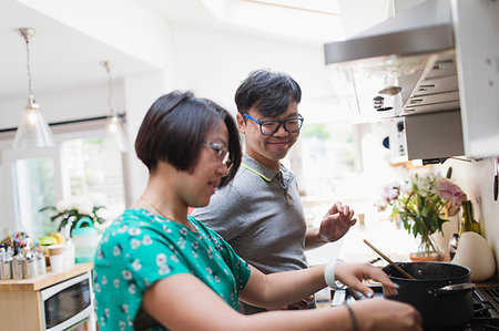 simsearch:6113-08550102,k - Couple cooking at kitchen stove Stock Photo - Premium Royalty-Free, Code: 6113-09199932