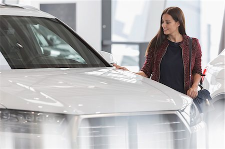 single car front - Female customer shopping for new car in car dealership showroom Stock Photo - Premium Royalty-Free, Code: 6113-09111854