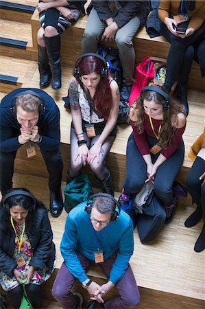 simsearch:6113-09131163,k - Overhead view audience listening with headphones Photographie de stock - Premium Libres de Droits, Code: 6113-09131142