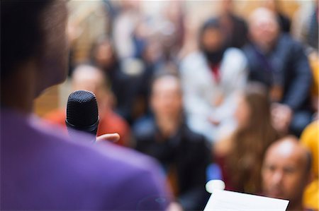 event business microphone - Businessman with microphone speaking to conference audience Stock Photo - Premium Royalty-Free, Code: 6113-09131161