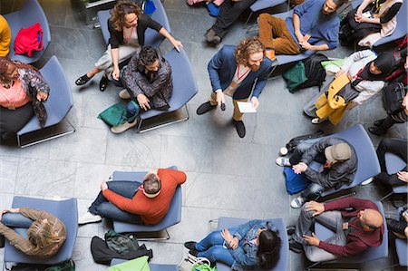 simsearch:6109-08830506,k - Overhead view conference audience listening to speaker with microphone Photographie de stock - Premium Libres de Droits, Code: 6113-09131179