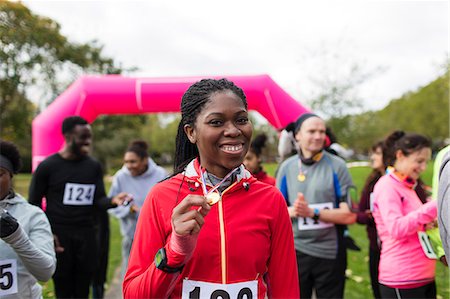 simsearch:649-05648783,k - Portrait confident female runner showing medal at charity run Stock Photo - Premium Royalty-Free, Code: 6113-09131197