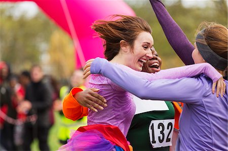 sport women candid - Enthusiastic female runners finishing charity run, celebrating Stock Photo - Premium Royalty-Free, Code: 6113-09131195