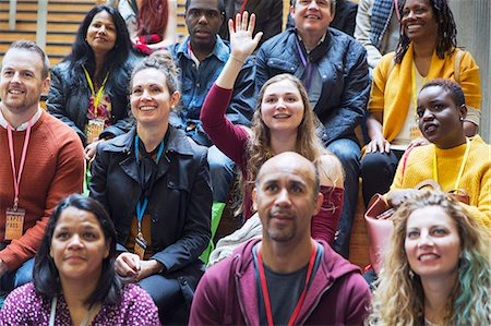 simsearch:6109-08830506,k - Woman participating, raising hand in conference audience Photographie de stock - Premium Libres de Droits, Code: 6113-09131133