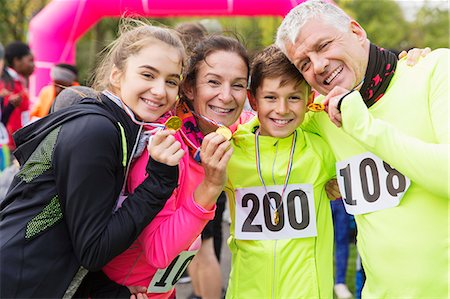 dad exercising - Portrait smiling, confident family runners showing medals at charity run Stock Photo - Premium Royalty-Free, Code: 6113-09131244