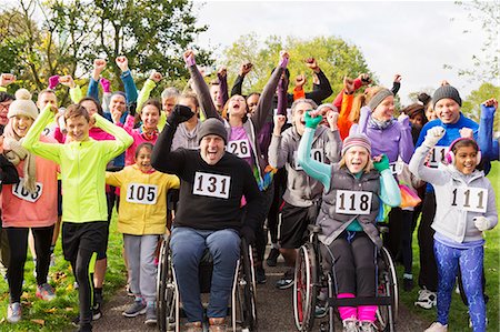 Portrait enthusiastic crowd cheering at charity run in park Stock Photo - Premium Royalty-Free, Code: 6113-09131231