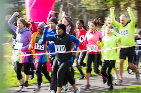 simsearch:649-06490133,k - Enthusiastic runners cheering and running at charity run in park Stock Photo - Premium Royalty-Free, Code: 6113-09131330