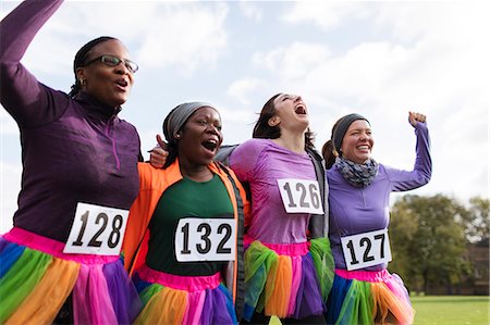 Enthusiastic female runner friends in tutus cheering at charity run Photographie de stock - Premium Libres de Droits, Code: 6113-09131400