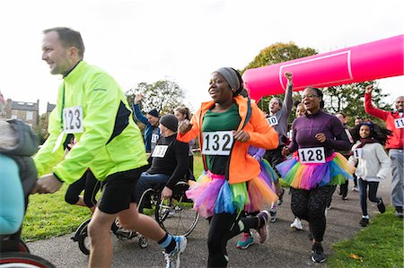 Enthusiastic runners running at charity run in park Stock Photo - Premium Royalty-Free, Code: 6113-09131405
