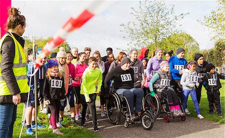 simsearch:640-08089401,k - Crowd of runners and people in wheelchairs waiting at charity race starting line Stock Photo - Premium Royalty-Free, Code: 6113-09131412