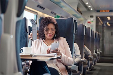 rail transport - Businesswoman working and listening to music with headphones and smart phone on passenger train Stock Photo - Premium Royalty-Free, Code: 6113-09131657